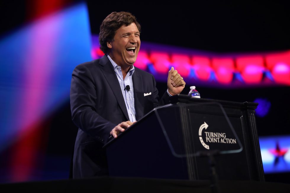 Tucker_Carlson_at_Turning_Point_Action_Conference_2023_free_wikimedia